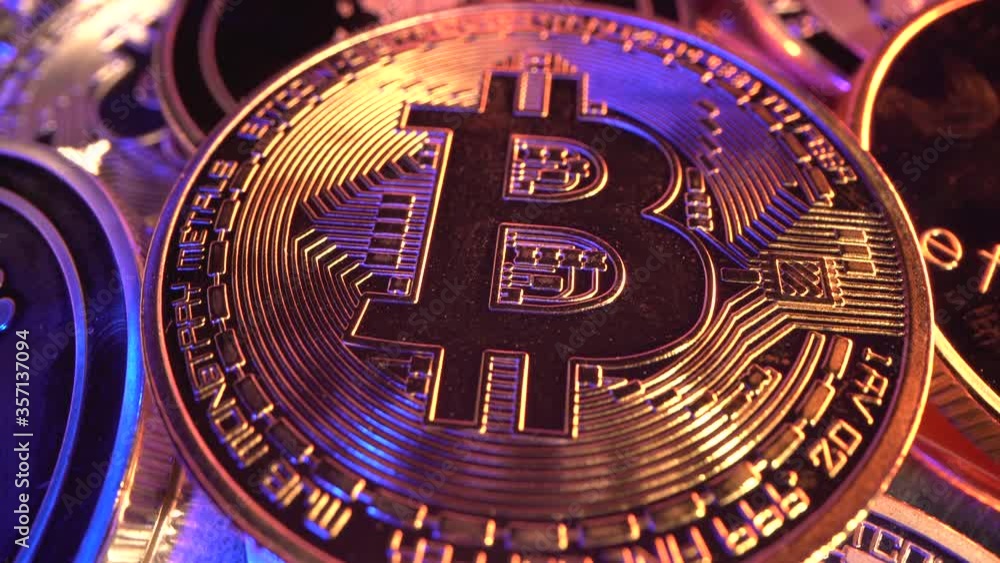Macro Bitcoin BTC with gold and blue neon light with many reflections. Halving. Mining. Cryptocurrency. Money of the future Macro Bitcoin BTC with gold and blue neon light with many reflections. Halving. Mining. Cryptocurrency. Money of the future
