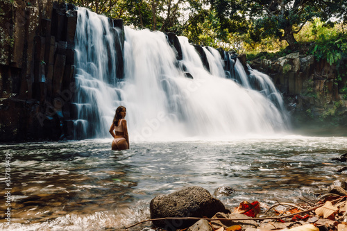 Rochester Falls and sexy woman in bikini. Amazing cascade waterfall in Mauritius