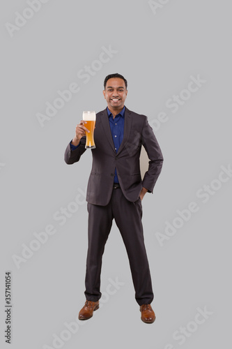 Businessman Holding Beer Glass. Indian Business man Standing Full Length with Beer in Hand