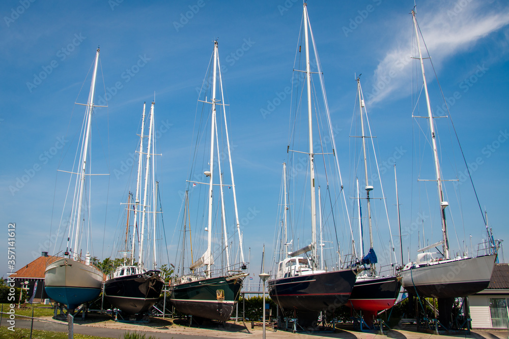 Shipyard with large sailing boats on dry land in the Netherlands in the town of Hindeloopen, province of Friesland