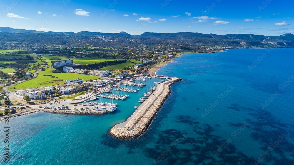 Aerial bird's eye view of Latchi port, Akamas peninsula, Polis Chrysochous, Paphos,Cyprus. Latsi harbour with boats and yachts, fish restaurant, promenade, beach tourist area and mountains from above Aerial bird's eye view of Latchi port, Akamas peninsula, Polis Chrysochous, Paphos,Cyprus. Latsi harbour with boats and yachts, fish restaurant, promenade, beach tourist area and mountains from above