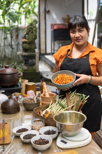 jamu herbal drink. asian woman jamu maker with spice ingredient photo