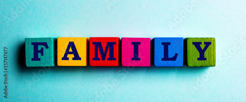 Fotografija The word FAMILY is made up of multi-colored cubes on a blue background