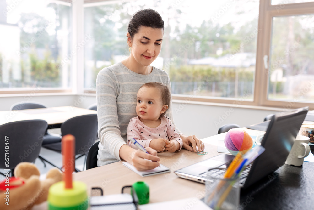remote job, multi-tasking and family concept - mother with baby working at home office remote job, multi-tasking and family concept - mother with baby working at home office