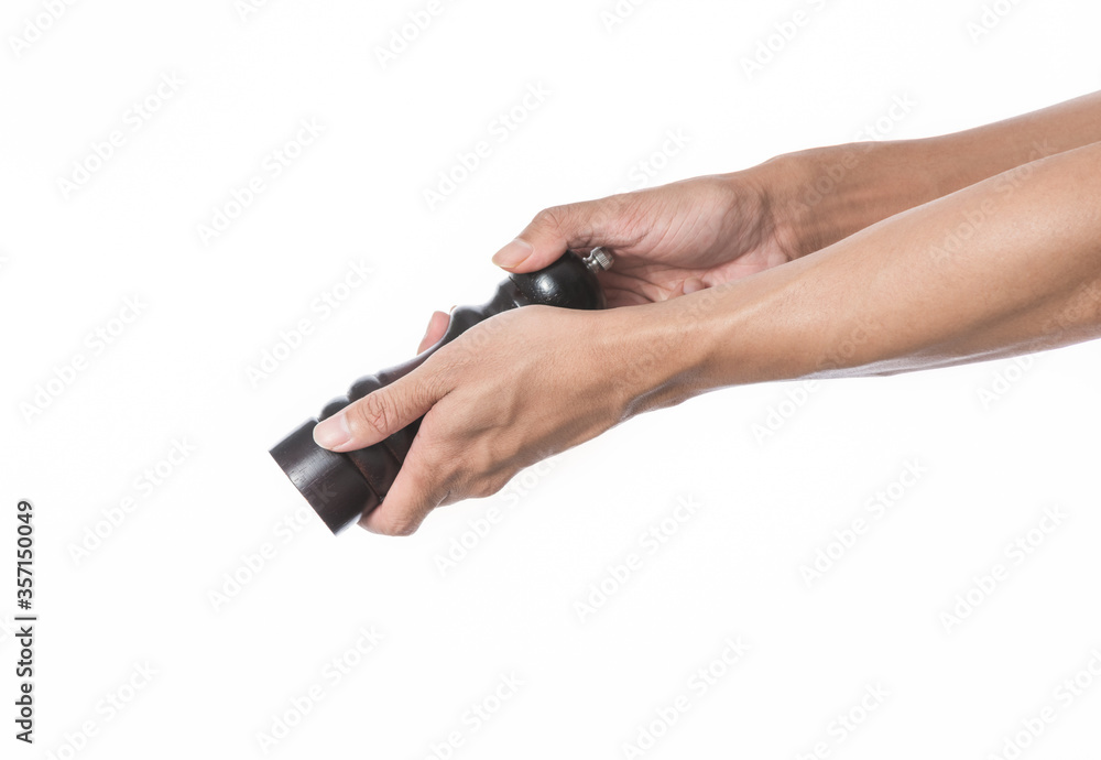 hand holding pepper wood bottle on white background hand holding pepper wood bottle on white background