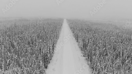 Amazing drone, aerial view of the wild & isolated Dempster Highway in northern Canada, Yukon Territory. Snowy & cold view of an isolated road in the north. 