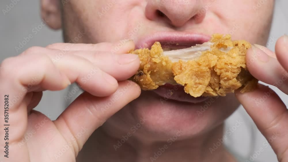 Woman eating fried chicken fast food closeup. Woman eating fried chicken fast food closeup.