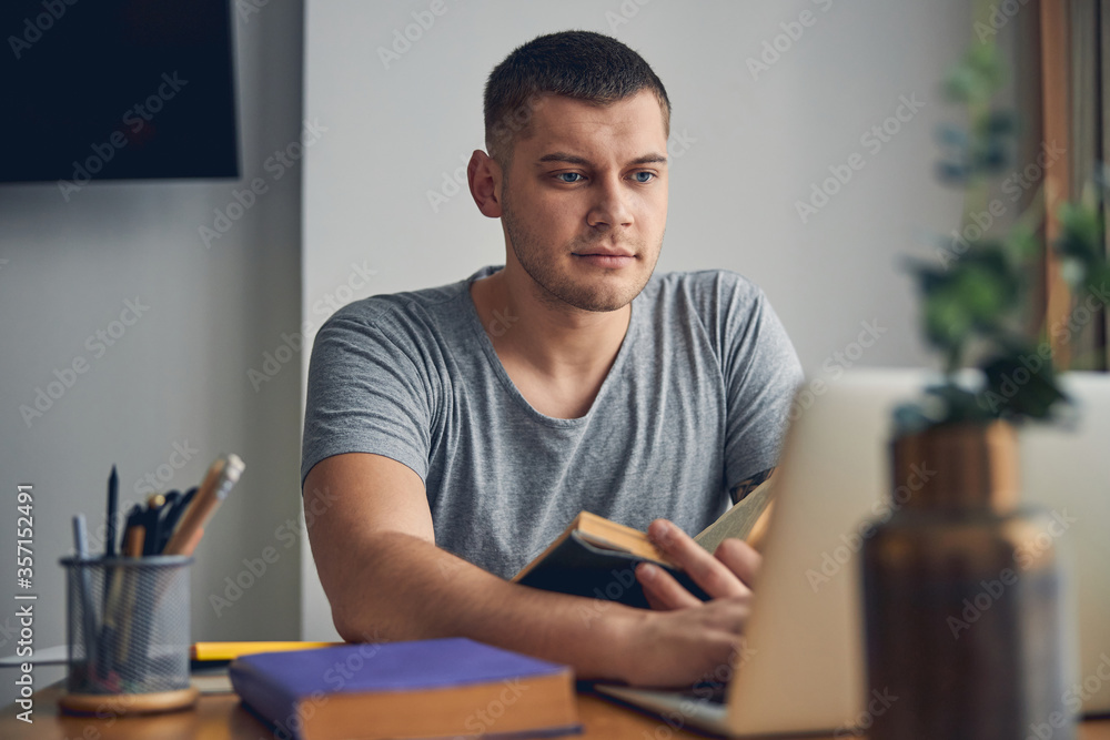 Man looking serious working with his laptop Man looking serious working with his laptop