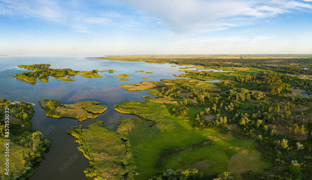 aerial view of islands with lush greenery in a freshwater river in summer. European landscape.