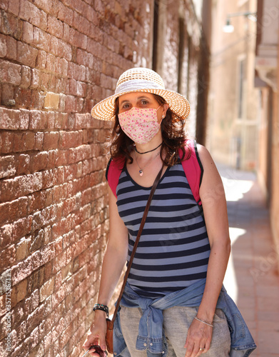 Woman with straw hat and surgical mask during the Corona Virus p