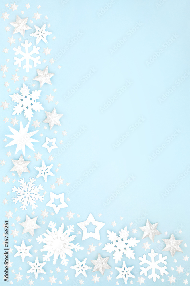 Christmas snow covered border with white star, snowflake & ball bauble decorations on pastel blue background. Xmas & winter & New Year composition for the festive holiday season. Christmas snow covered border with white star, snowflake & ball bauble decorations on pastel blue background. Xmas & winter & New Year composition for the festive holiday season.