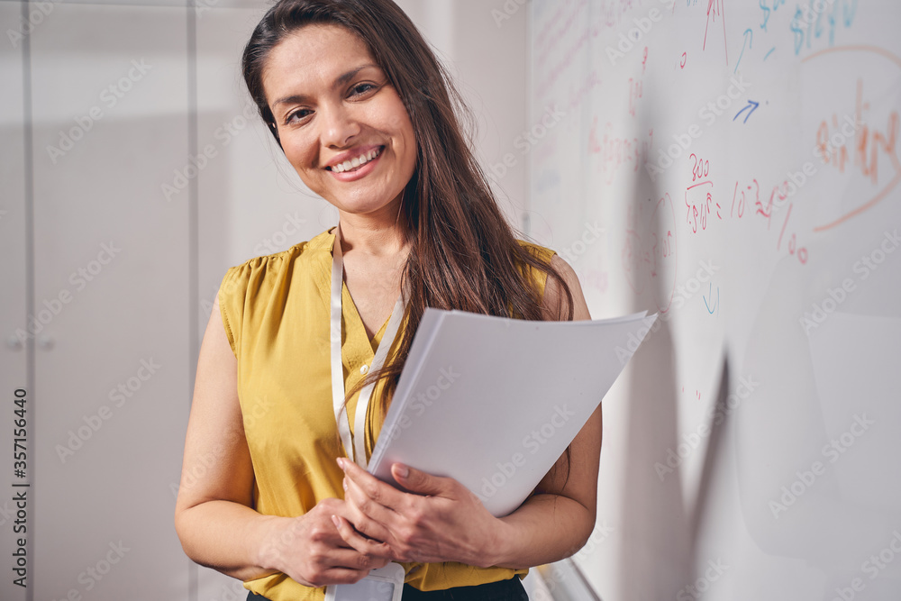 Close up of cheerful woman that standing near board Close up of cheerful woman that standing near board