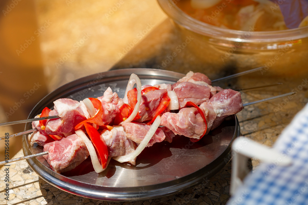 Raw kebabs of pork chopped into pieces and put on skewers ready for frying on the grill. Raw kebabs of pork chopped into pieces and put on skewers ready for frying on the grill.