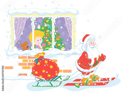 The night before Christmas, a little boy looking through a window at Santa Claus skiing with a sledge and his big bag of holiday gifts, vector cartoon illustration