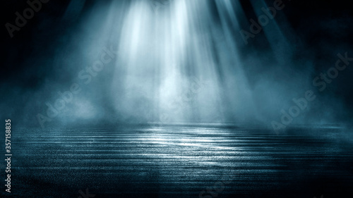 Dark dramatic abstract scene background. Neon glow reflected on the pavement. Smoke, smog and fog. Dark street, wet asphalt, reflections of rays in the water. Abstract dark blue background.  © MiaStendal