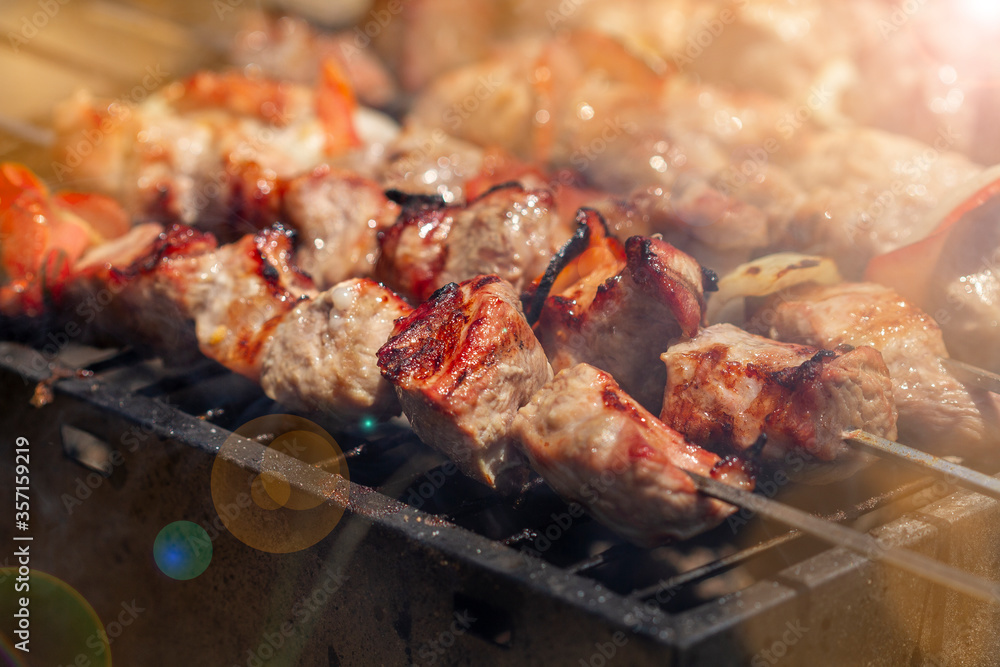 Beautiful juicy kebabs are prepared on the grill on the nature. Rest at 