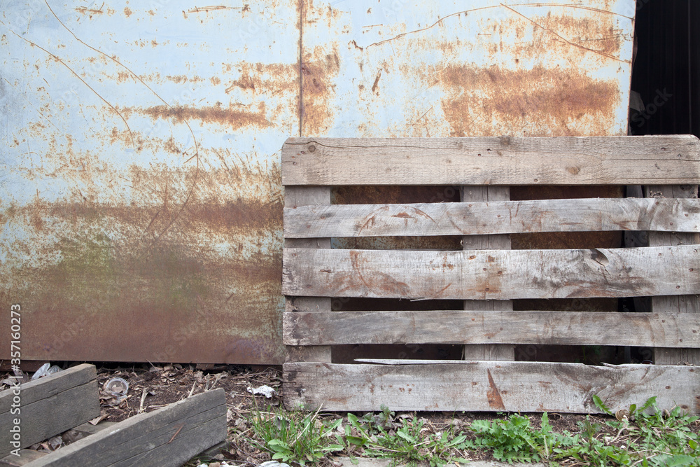 Wooden box near a rusty metal wall Wooden box near a rusty metal wall