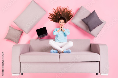 Top view above high angle flat lay flatlay lie concept of her she nice attractive lovely amazed cheerful glad girl sitting on divan spending time leisure isolated over pink pastel color background