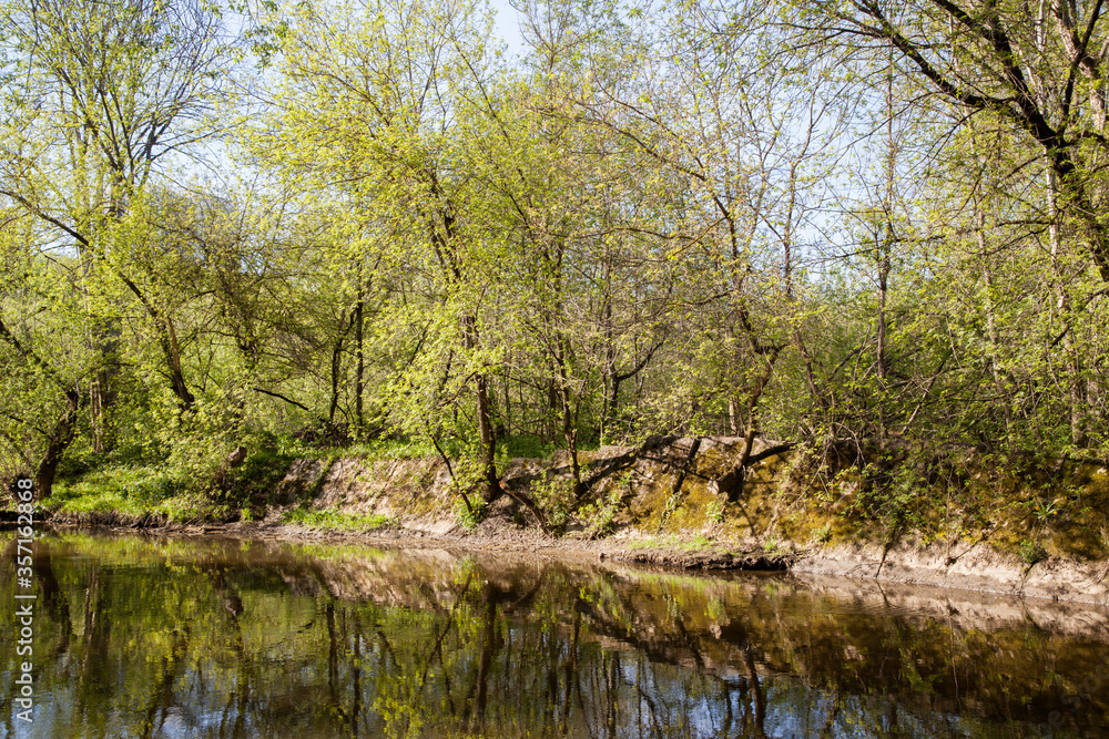 Old concrete banks by the river, concrete slabs covered with moss