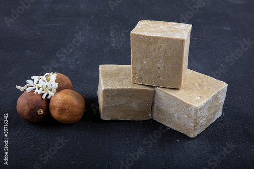 Natural handmade soap and bay leaves (laurel) on black wood background. photo