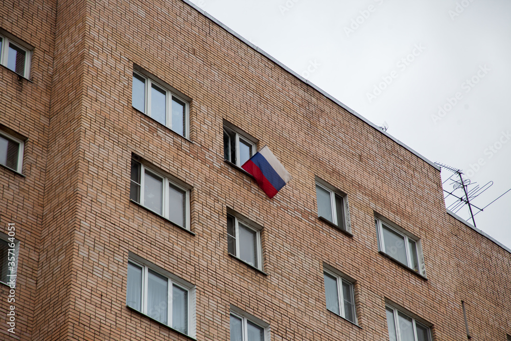 Russian flag in the window of a residential building