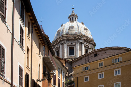 Bottom view of a historical building in Rome with clear blue sky in the background.