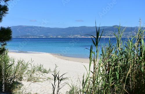 Fototapeta Naklejka Na Ścianę i Meble -  Bay with turquoise water and beach with white sand and blue sky. San Francisco beach, Muros, Galicia, Spain.