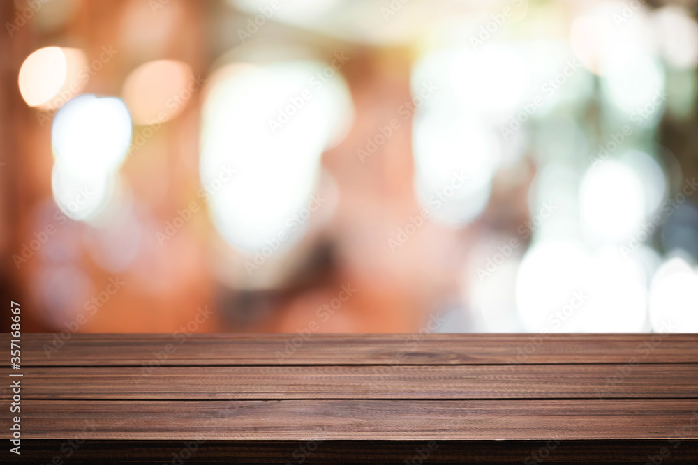 Empty wooden table space platform and blurred resturant or coffee shop background for product display montage. Empty wooden table space platform and blurred resturant or coffee shop background for product display montage.