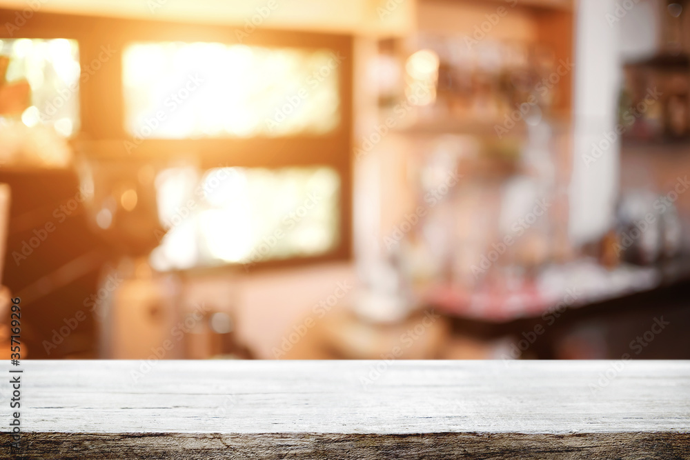 Empty wooden table space platform and blurred restaurant or coffee shop background for product display montage. Empty wooden table space platform and blurred restaurant or coffee shop background for product display montage.