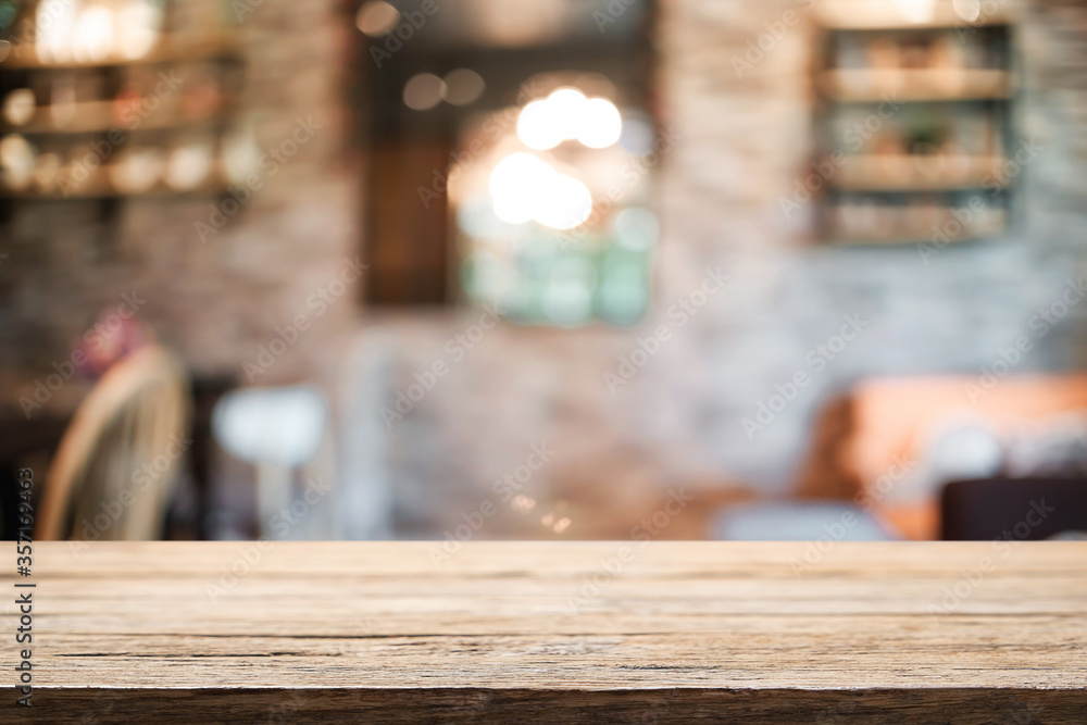 Empty wooden table space platform and blurred restaurant or coffee shop background for product display montage. Empty wooden table space platform and blurred restaurant or coffee shop background for product display montage.