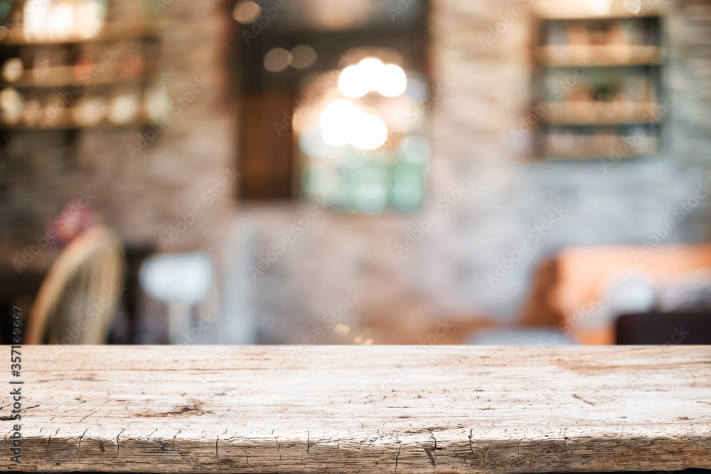 Empty wooden table space platform and blurred resturant or coffee shop background for product display montage. Empty wooden table space platform and blurred resturant or coffee shop background for product display montage.