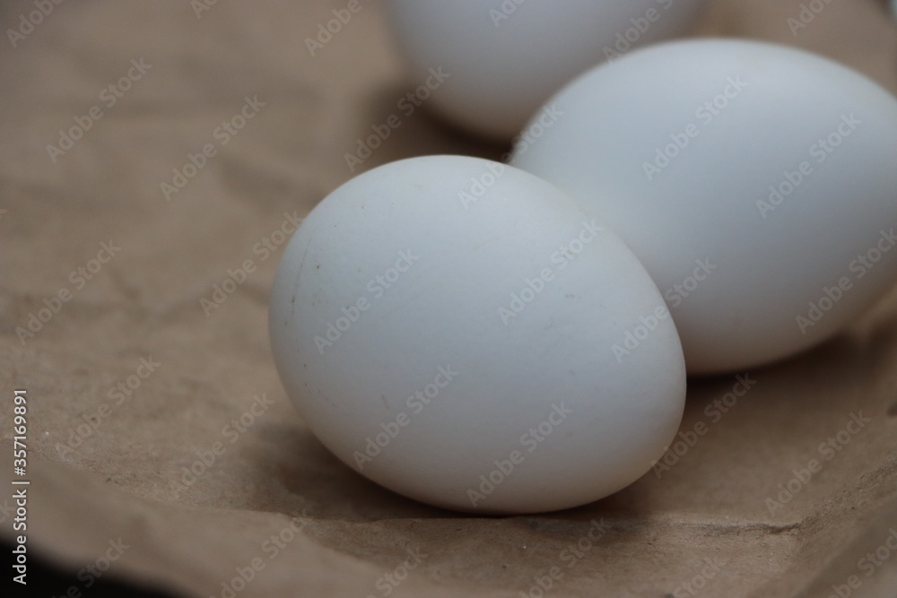 White eggs on brown background, healthy food White eggs on brown background, healthy food