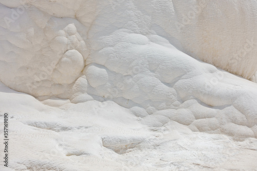 Details of white carbonate mineral rocks made by water flow at Pamukkale near archelological site Hierapolis, Denizli, Turkey