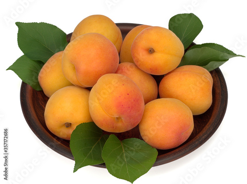 Fresh apricot fruits in a plate isolated on a white background