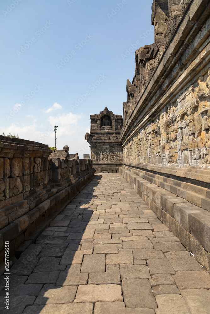 One of the corridors, on the lower levels, of the eastern part of the Borobudur temple, Central Java, Indonesia, decorated with exquisite reliefs of mythological scenes.