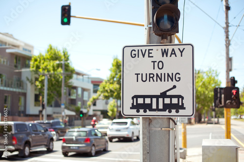 Road sign. Pedestrians give way to turning tram. Australia, Melbourne.