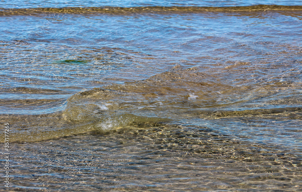 Small vortices in the crystal clear waters of the sea on the shore. Pomorie resort, Bulgaria. Small vortices in the crystal clear waters of the sea on the shore. Pomorie resort, Bulgaria.