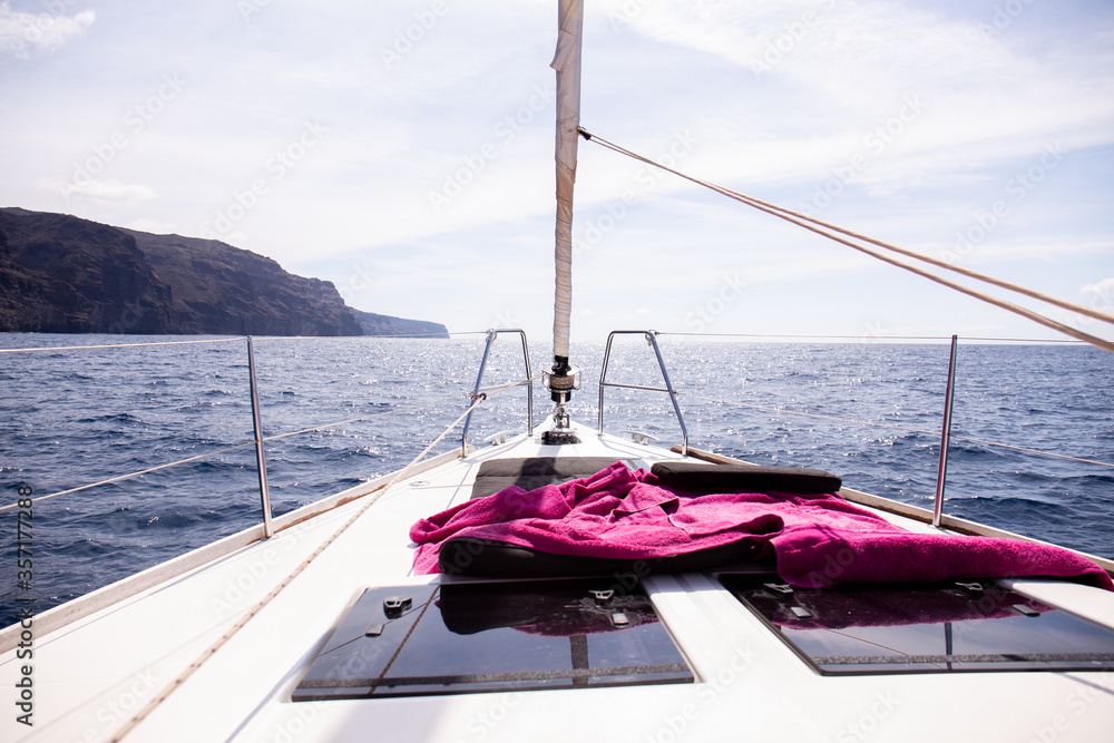 Obraz premium view from yacht at rock in Atlantic ocean and blue sky in Maspalomas, Gran Canaria