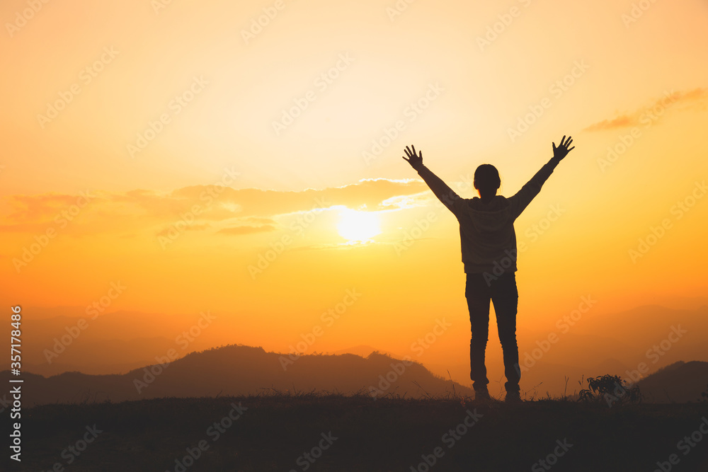 Man rise hand up on top of mountain and sunset, Freedom and travel adventure concept. Religious beliefs, Copy space. Man rise hand up on top of mountain and sunset, Freedom and travel adventure concept. Religious beliefs, Copy space.