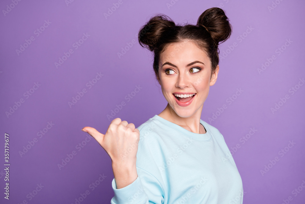 Portrait of positive cheerful energetic girl millennial point thumb finger copyspace indicate advert promotion recommend suggest select wear trendy outfit isolated violet color background