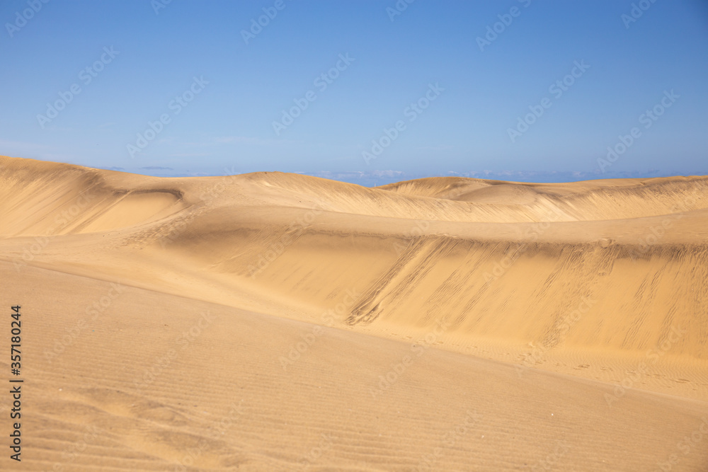 Fototapeta premium sand dunes against clear blue sky in Maspalomas, Gran Canaria