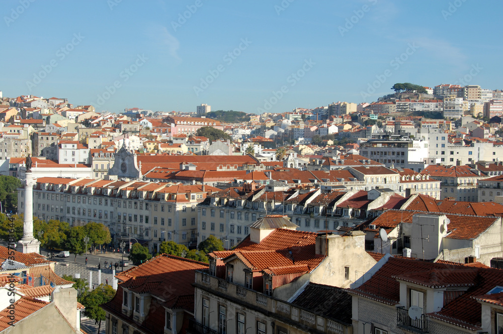 Lisbon rises on the coast and is on a hilly area. From São Jorge Castle, the view is on the pastel-colored buildings of the old city, the Tagus Estuary and the 25 de Abril bridge.