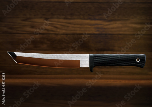 Tanto knife wooden background