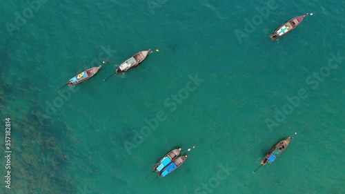 Aerial view, flying over the sea. Fishermen boats mouring vertical point of view. Drone dji mavic air 4K 30fps photo