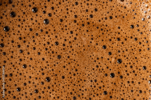 Brown coffee foam with bubles top view