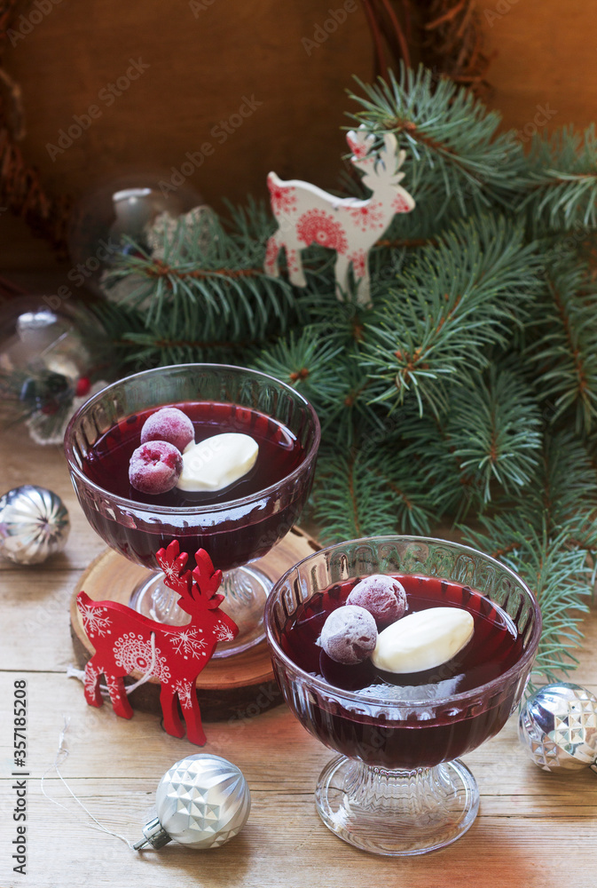 Cherry jelly with cream and berries in a Christmas or New Year decoration.