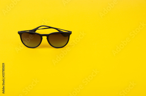 Stylish Sunglasses on Bright Yellow Background