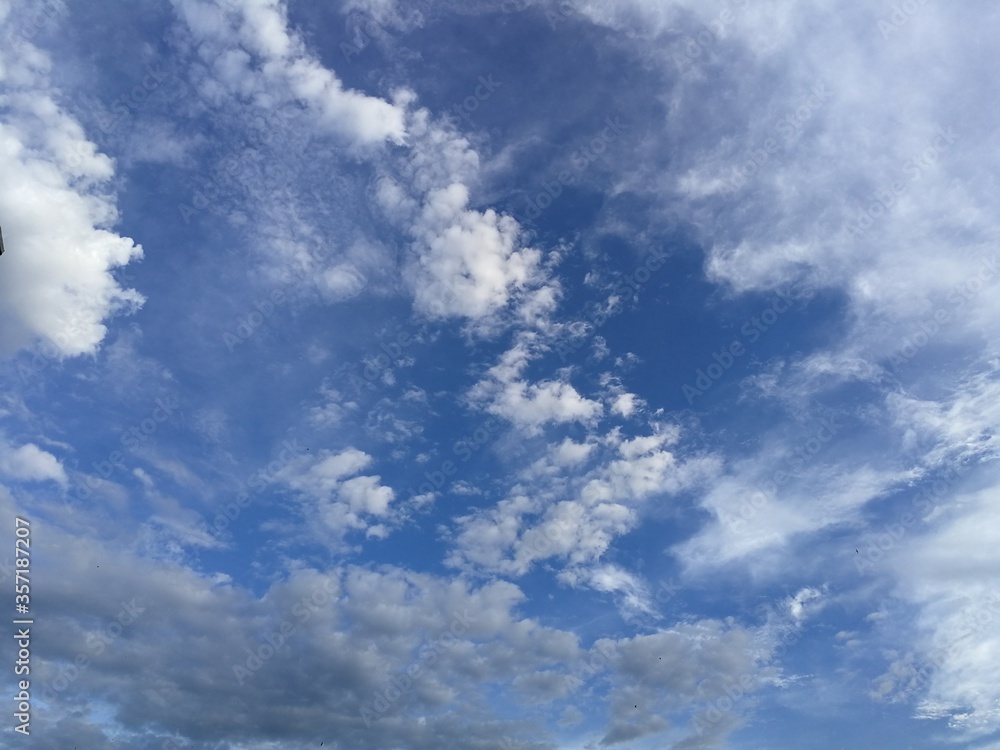 Obraz premium Slight clouds in blue sky, low angle view. Rainy season, clouds and sky in rainy season.