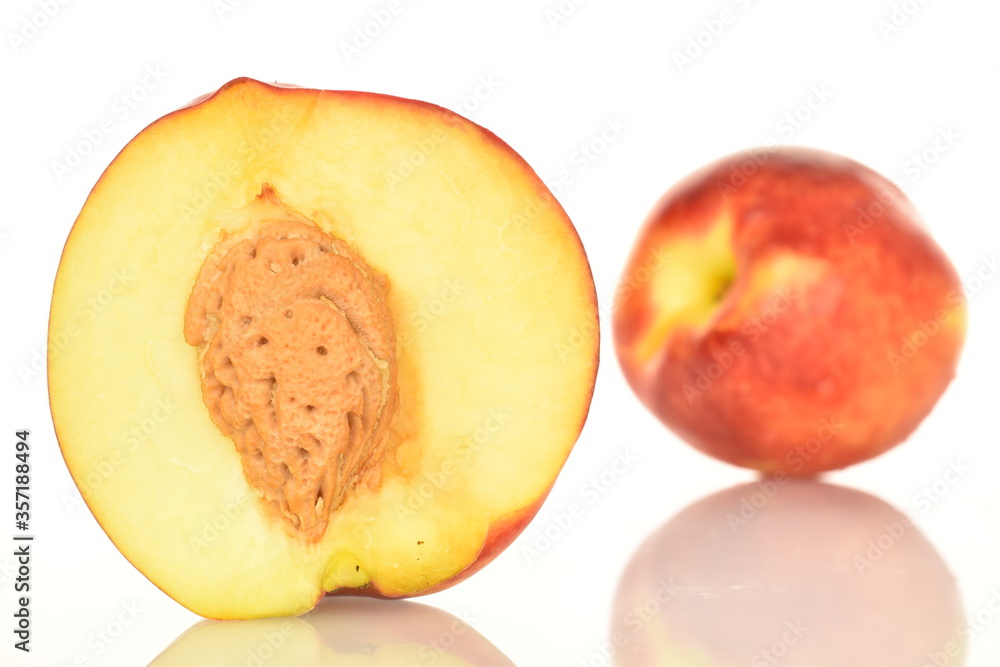 Ripe juicy organic nectarine, macro, on a white background. Ripe juicy organic nectarine, macro, on a white background.