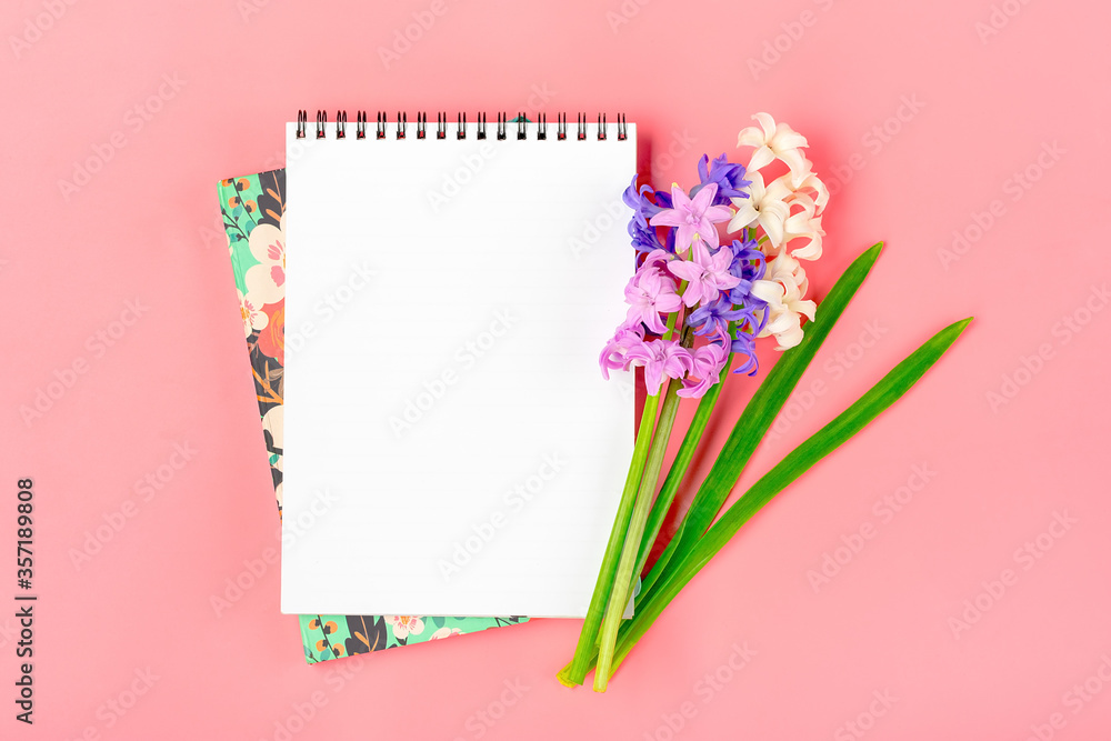 Workplace with bouquet of hyacinths flowers, white notepad on pink background Flat lay Top view copy space Mock up Sesonal, education concept Floral holiday card Place for text Workplace with bouquet of hyacinths flowers, white notepad on pink background Flat lay Top view copy space Mock up Sesonal, education concept Floral holiday card Place for text